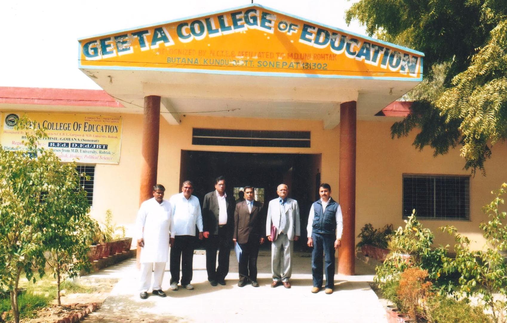 NCTE inspection team outside the college entrance, archival photo